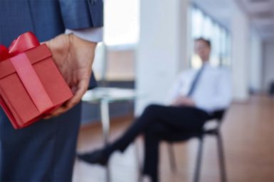 Businessman going to give present to his boss