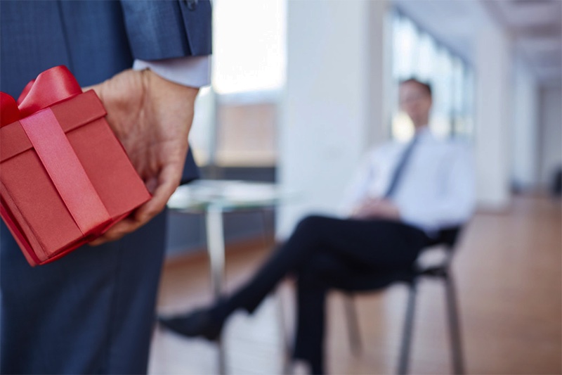 Businessman going to give present to his boss
